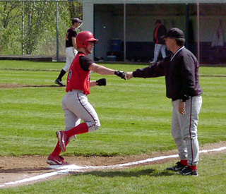 Dan Riener is congratulated by coach Pat Holthaus on his 2-run homer in the third inning against Troy.
