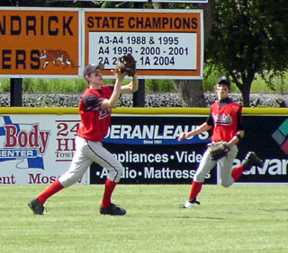 Eric Daly makes a catch in left field as Nate Kaschmitter comes over to back up the play.
