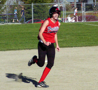 Kim Schaeffer heads for third with a triple in the third inning and then scored when the throw went into the Prairie dugout, ending the game on the 15-run rule.