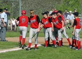 Ronnie Chandler is greeted at home after his leadoff homer put Prairie on the scoreboard.