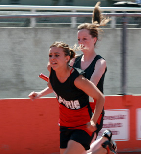 NaTosha Schaeffer hands off to Gina Holthaus in the 4x100 relay.