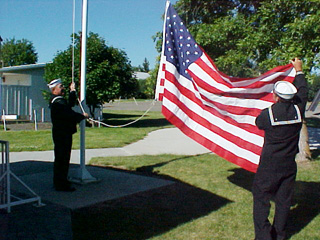 Dean Shears and his father David Shears Sr. raise the flag they donated to the city.