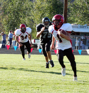 David Sigler heads toward the left sideline at the start of his punt return for a TD. At left is Nick Johnson.