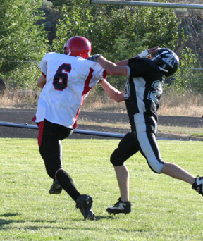 Branden Waller wards off the final defender with a chance to tackle him on his long touchdown run.