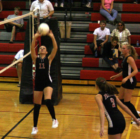 Alli Holthaus makes a set. At right are Kim Schaeffer, #2, and Chelsey Long.