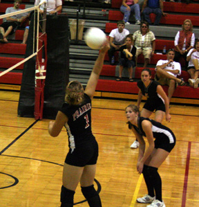Chantel Boniecki spikes the ball at C.V. At right are Kim SChaeffer and Kaylee Uhlenkott.