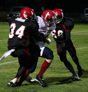 Nick Johnson and Andy Groom combine on a sack of the Lewis County quarterback.