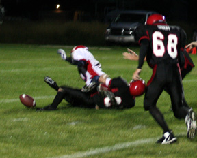 Mike Matson knocks the ball loose from Lewis County's quarterback. Conner Rieman would pick it up and score a touchdown. #68 is Andy Groom.