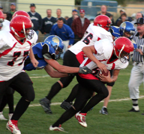 Kyle Daly breaks loose from a would be tackler and winds up in the end zone 55 yards away for the game's first score. At left is Ronnie Chandler while behind Daly is Kyler Shumway.