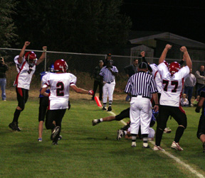 Branden Waller and Ronnie Chandler signal touchdown as Kyle Holthaus has gone over from the 2 (behind referee's legs.) #2 is Conner Rieman.