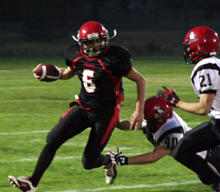 Kyle Daly is about to get tackled on a run.