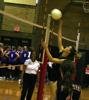 Alli Holthaus spikes the ball at the Gar-Pal Tournament. #4 is Sam Frei.