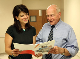 Casey Meza and Dr. Maurice look over the article in Idaho Business Review in which they're honored.