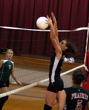 Tiffany Schaeffer blocks the ball at the net.