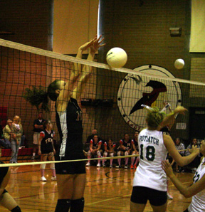 Tiffany Schaeffer stuffs a spike at Gar-Pal.