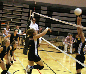 Chantel Boniecki spikes the ball past a Highland block. At left are Brianne Stubbers, Kim Schaeffer and Kaylee Uhlenkott.
