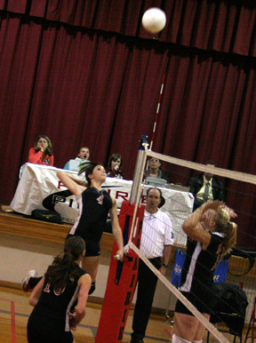 Sam Frei winds up for a big hit against Kendrick. In front is Tiffany Schaeffer.