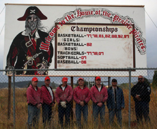 The new sign with the crew that painted and built it.