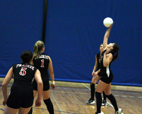 Brooke Holthaus pounds the ball over from the back row. Others from left are Kaylee Uhlenkott, Chantel Boniecki and Brianne Stubbers.