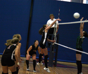 Kim Schaeffer spikes the ball past a Culdesac blocker. Also shown from left are Chantel Boniecki, Brianne Stubbers and Brooke Holthaus.