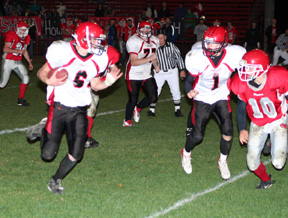 Branden Waller carries for the Pirates. #77 is Ronnie Chandler and #1 is David Sigler.