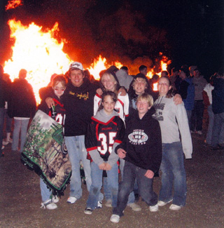 Some students in front of the bonfire after the powderpuff game last Wednesday.