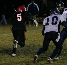Kyle Daly has just reversed his field as one Lapwai defender inadvertantly blocks for him against another Lapwai defender. Daly wound up getting around the corner to the left and going for a touchdown.