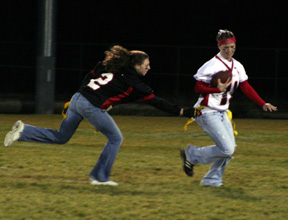 Tiffany Schaeffer tackles her cousin Kara Guyer for a loss inthe Powderpuff game.