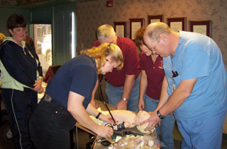 Kamiah EMTs and nursing staff at St. Mary's and Clearwater Valley Hospitals attended a training session sponsored by Idaho State University on Pediatric Respiratory Illnesses and Interventions.  Working with the life like infant (clockwise) are Jennifer Cochran, EMT, Diana Holubetz, EMT, Bill Simmons, Kamiah EMT; Ronda Ellers, Kamiah EMT and Charles Butler, RN/Paramedic.