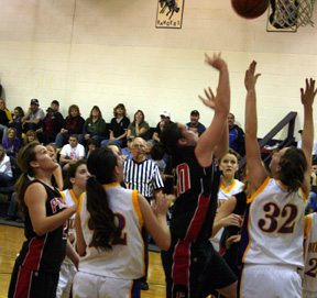 Kaylee Uhlenkott shoots a lay-up against Garden Valley. Kristi Poxleitner is at left.
