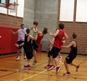 Joe Schumacher checks David Sigler's shot.