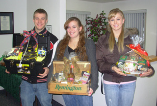 Andy Groom, Emily Lerandeau and Chelsea Long show some of the prize baskets available in the PHS junior class prize drawing.