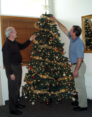 Jim May (l) and Don Murphy, PT, decorate a tree in preparation for the holiday open house being hosted by St. Marys Hospital on Wednesday, December 19. The community is invited.