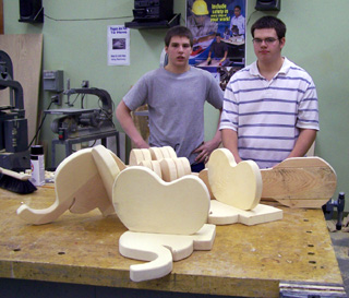 Brandon Ross and Joe Schumacher with parts for elephant-head rocking horses.