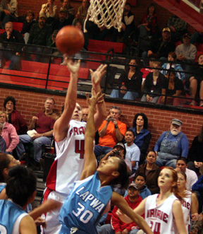 Kaylee Uhlenkott puts up a shot against Lapwai. At right are Sarah Arnzen and Jennifer Enneking.
