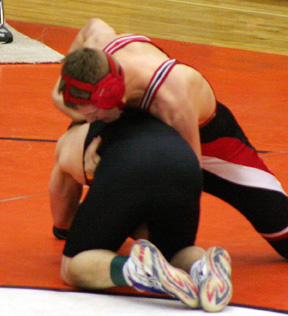 Ronald George attempts to turn his opponent on his way to a second place medal.