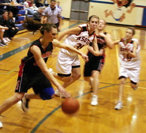 Tiffany Schaeffer drives toward the hoop from the corner.