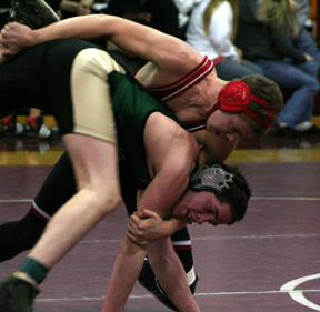 Jake Wimer drives an opponent to the mat for a takedown.