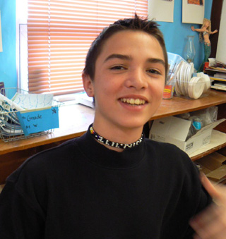 Nick Hartnett shows off the necklace he made.