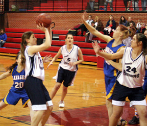 Rachel Wemhoff puts up a shot for the Lady Patriots. At right are Danielle (#5) and Tara (#24) Stubbers.