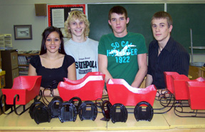 Justina Zigler, Kris Banning, Michael Matson, and Andy Groom with sleighs and horseshoe picture frames.  Randy and Zara Hasselstrom donated the horseshoes for the picture frames and coat racks.  The metal for the sleighs was donated by Hometown Auto.