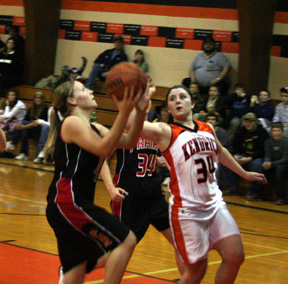 Jennifer Enneking shoots a lay-up. #34 in black is Sarah Arnzen.