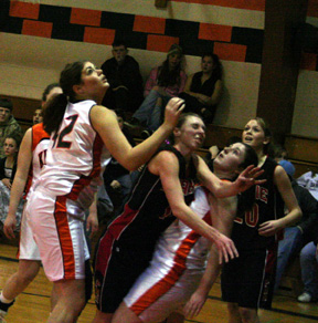 Tiffany Schaeffer gets sandwiched by a pair of Kendrick players after taking a shot. She wound up at the foul line, making both shots.
