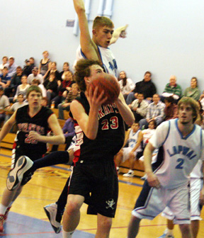 David Sigler shoots a lay-up at Lapwai. In the back is Kenneth Enneking.