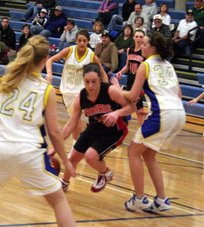 Kaylee Uhlenkott drives into the lane at Genesee. In the background is Tiffany Shaeffer.