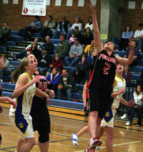 Kristi Poxleitner goes for a lay-up at Genesee as Hilaree VanderPas watches.