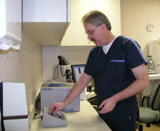 Kevin Daly, SMHC Lab Manager, demonstrates the new chemistry analyzer recently purchased with grant funds.