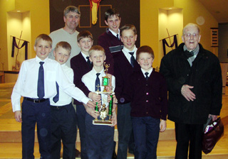 Summit's boys with the Sportsmanship trophy. Fr. Hallissey is at right.