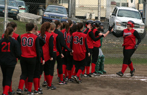 Hilaree VanderPas is greeted at home plate by all her teammates after the first of her 3 home runs in the game against St. Maries.