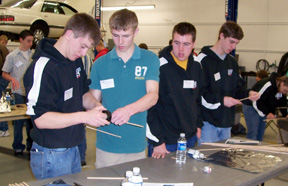 Kyle Holthaus, Steven Baerlocher, Chance Ratcliff and Eric Daly work on building bridges.